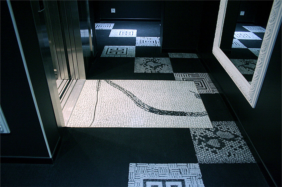 the mosaic is within a decor principally in black and white